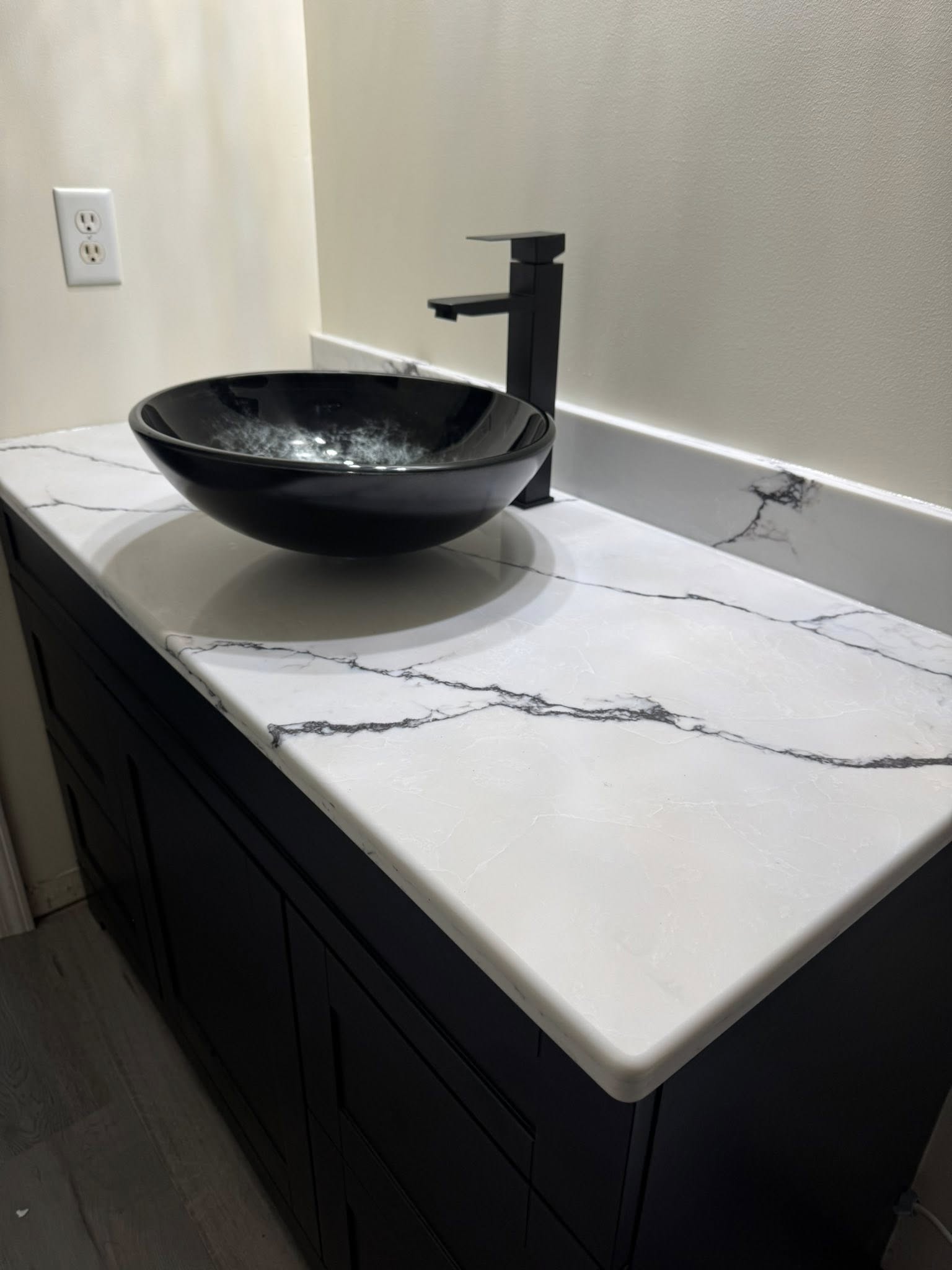 Finished black vessel sink and vanity installation