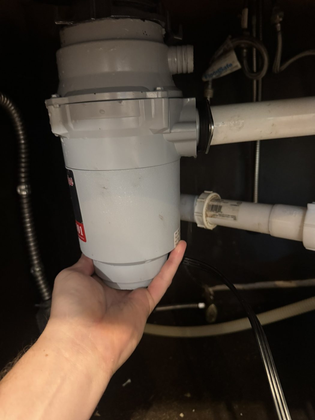 Old garbage disposal before replacement