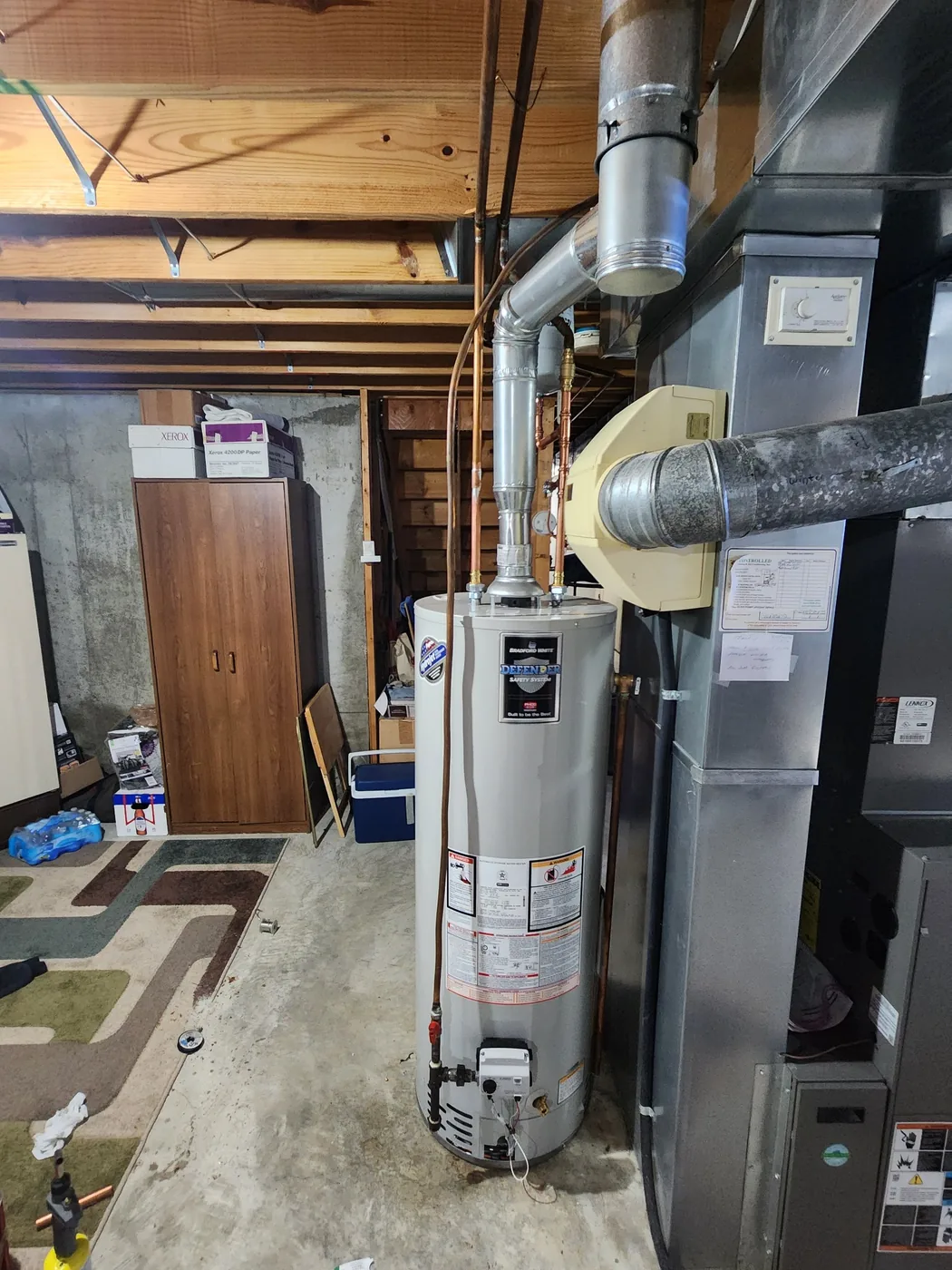 Bradford White gas water heater professionally installed beside a furnace