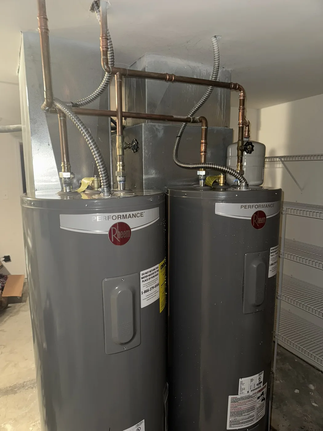 Two Rheem electric water heaters installed together for increased hot water capacity